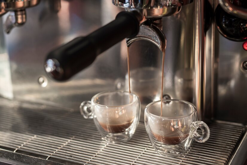 close-up-espresso-pouring-into-cups_23-2148349621